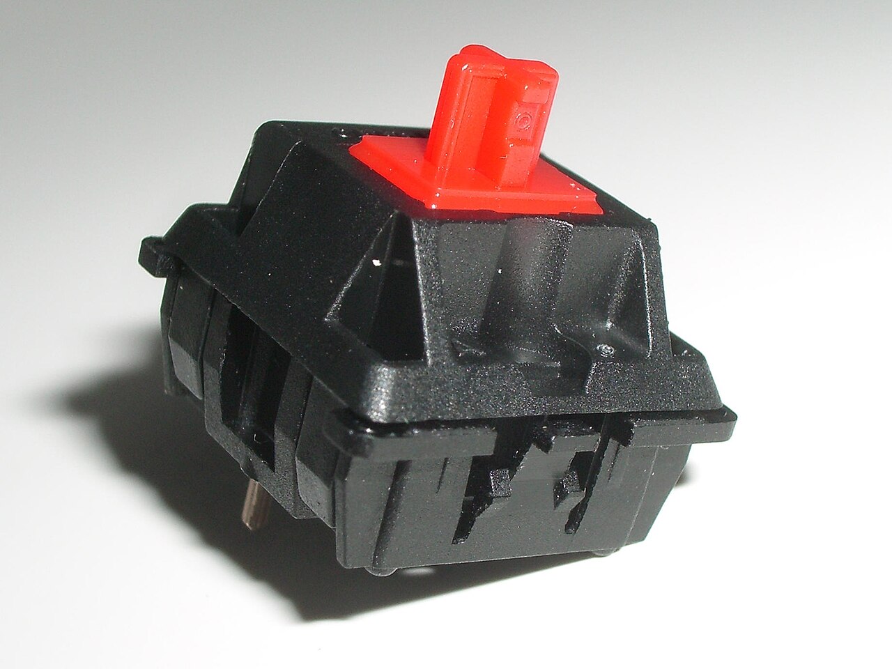 Cherry MX Red switch showing its stem and housing
