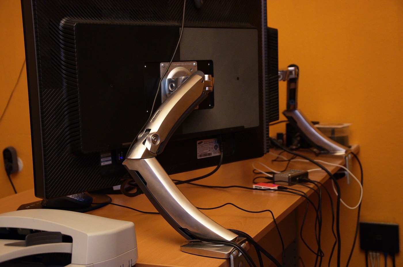 A desk-mounted monitor arm supporting a display